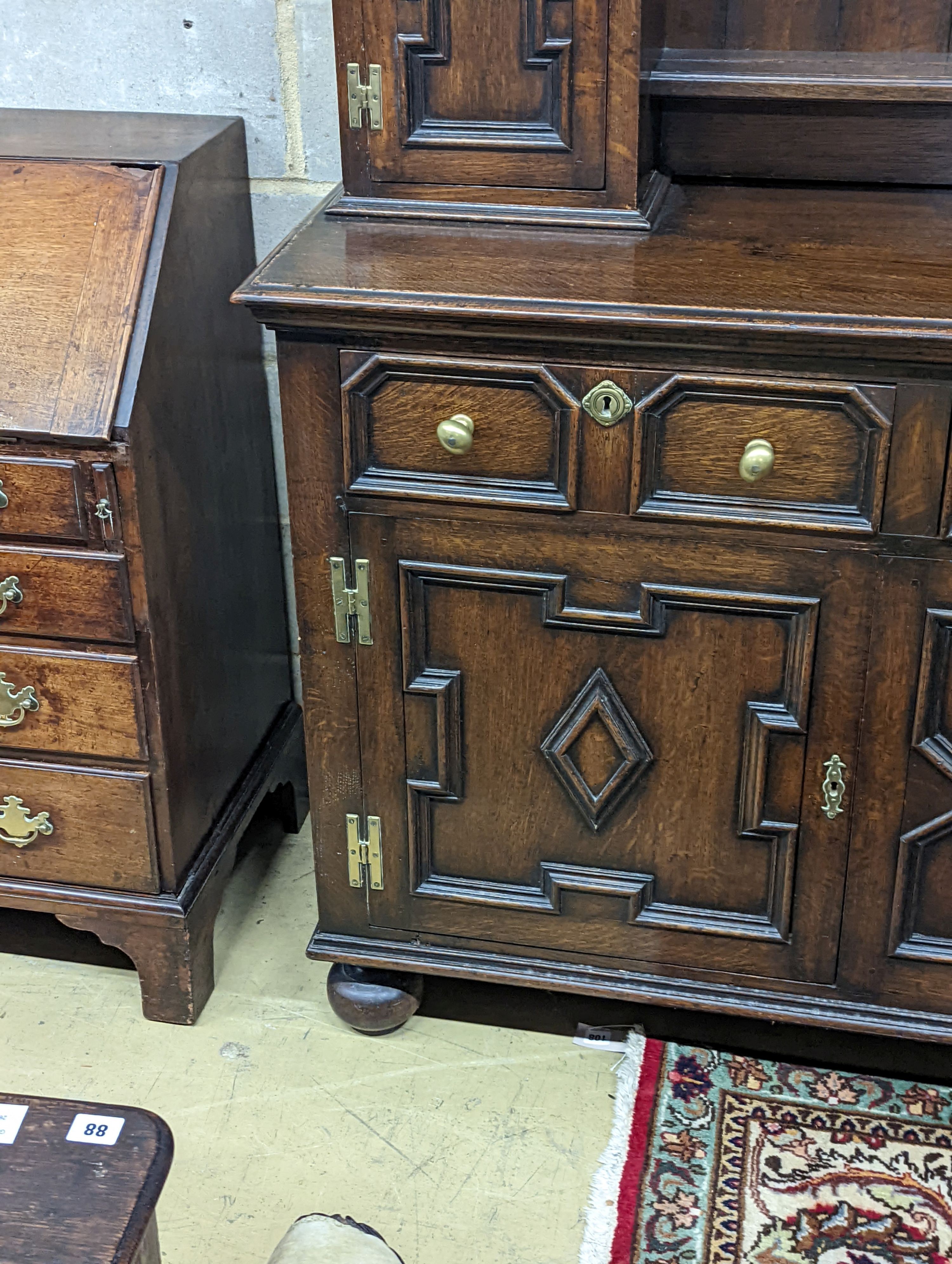 An early 20th century Jacobean revival oak dresser, width 168cm, depth 48cm, height 218cm